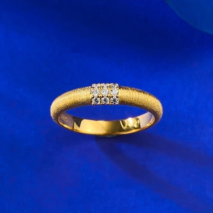 Macro detail of S925 stamp on matte gold ring with two rows of sparkling gemstones
