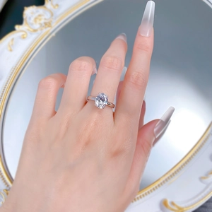 Detailed close-up of 4-carat oval cut gemstone ring on a woman finger