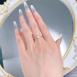 Detail of S925 silver gold ring featuring an oval clear stone with side micro-pave diamonds