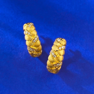 Textured gold wheat ear hoop earrings with micro-inlaid zircon on deep blue background