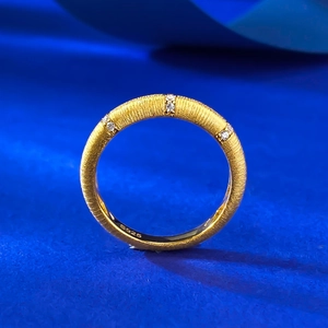 Macro detail of S925 sterling silver ring with brushed gold finish and cubic zirconia