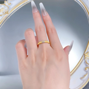 Close-up of golden brushed S925 silver ring with three rows of sparkling square diamonds