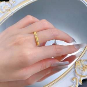 Close-up of matte brushed gold silver ring with sparkling zircon stones on model hand