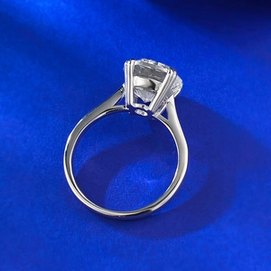 Classic silver ring with 10mm round brilliant cut diamond solitaire on blue texture