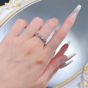 Close-up of S925 silver lace quilted ring with hollow patterns and small sparkling zircons