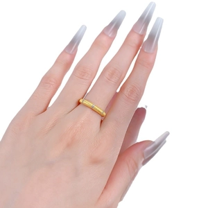 Minimalist gold satin brushed ring featuring three sparkling zircons on a model hand