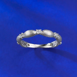 Macro detail of S925 sterling silver ring with brushed texture and tiny inlaid zircons