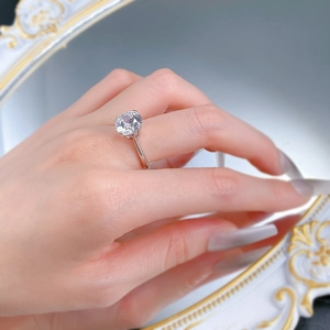 Macro view of a classic six-prong silver engagement ring with a round brilliant stone