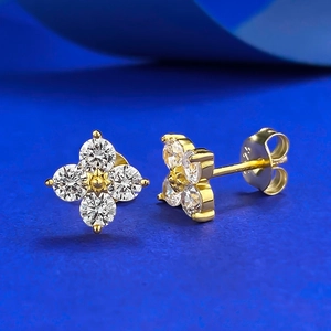 Detailed macro view of S925 sterling silver four-leaf clover earrings with zircon stones
