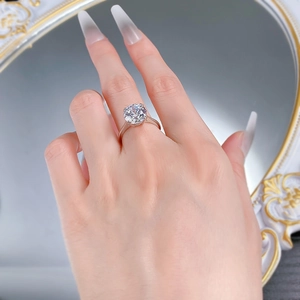 Detailed view of 10mm round cut ice flower diamond ring on finger with six-prong setting