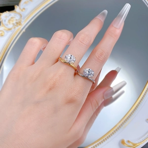 Close-up of gold and silver S925 adjustable rings with oval cut sparkling gemstones
