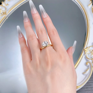 Detailed view of an oval-cut gemstone set on a golden wave-shaped ring band
