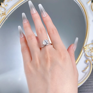 On-hand display of S925 silver ring with oval-cut gem and twisted band detail