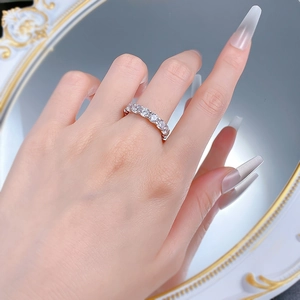 Macro shot of silver S925 band ring featuring full circle round-cut diamond pavé setting