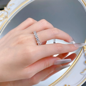 Macro shot of S925 sterling silver band with round claw-set cubic zirconia diamonds