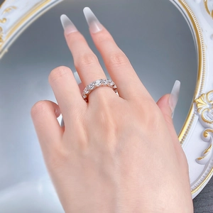 Close-up of S925 sterling silver eternity band with sparkling round cut diamonds on finger