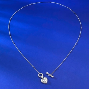 Detail of silver heart pendant necklace with bead chain and stylish OT clasp closure
