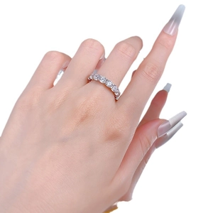 Eternity band with S925 sterling silver and round brilliant cut stones on a model's finger