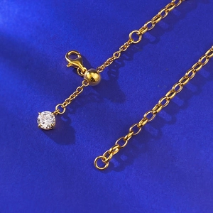 Detail of S925 silver star bracelet featuring adjustable gold ball and lobster clasp closure