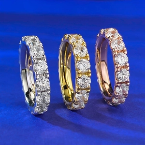 Three S925 sterling silver eternity rings with 4.0mm round diamonds on blue background