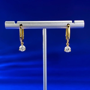 Detailed close-up of S925 silver hoop earrings with round-cut zircon on a metal display