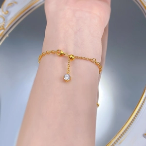 Close-up of S925 silver gold-plated bracelet featuring a four-claw set zircon on wrist