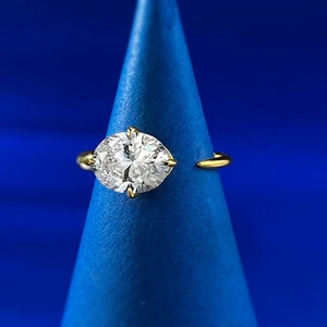 Detailed view of large oval-cut clear gemstone in a four-prong gold-plated setting