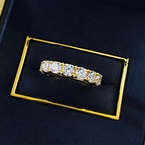 Macro shot of gold S925 silver ring with seven brilliant-cut round diamonds in a navy box