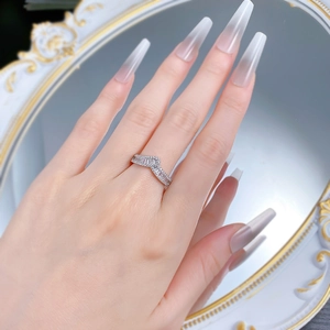 Detailed view of an S925 silver V-shaped ring with pavé diamonds worn on a finger