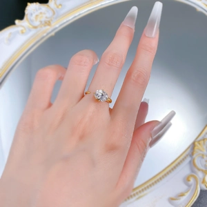 Detail of a 925 silver gold-plated ring with a sparkling oval zircon in a six-prong setting