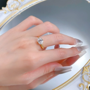 Close-up of gold plated S925 silver ring with oval solitaire stone on woman's hand