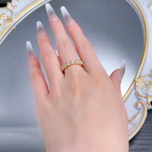Detail of a 4mm gold plated S925 silver ring with sparkling round cubic zirconia stones
