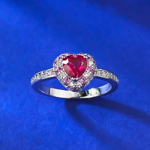 Macro detail of S925 sterling silver stamp and heart-shaped red gemstone ring