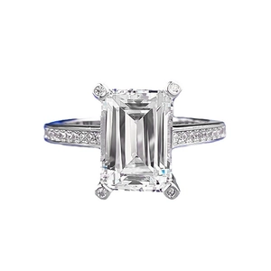 Elegant emerald cut moissanite ring with micro-paved silver band and claw setting