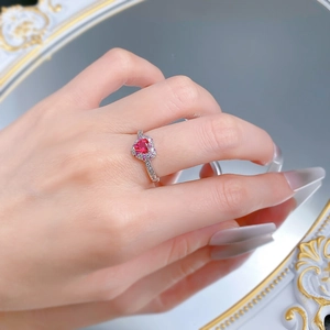 Close-up of S925 silver ring with a red heart-shaped gemstone and micro-pave diamonds