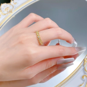 Close-up of a vintage hollow lace S925 silver ring with diamonds on a hand