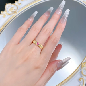 Detailed view of a gold S925 silver ring featuring a pink heart-shaped diamond on finger