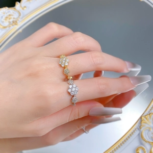 Macro shot of S925 silver floral band ring with bicolor finish and pave zircons