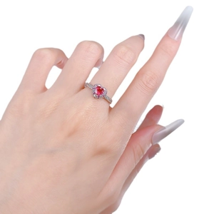 S925 sterling silver heart-shaped ruby ring with halo diamonds on a hand model