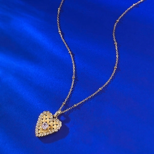 S925 gold-plated heart pendant necklace with pink stone on dark matte surface