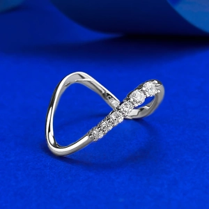 Minimalist S925 sterling silver wavy ring with sparkling pavé zircons on deep blue background