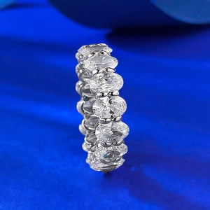 Elegant S925 sterling silver eternity ring featuring oval-cut gemstones on blue silk