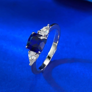 S925 silver ring featuring square blue sapphire and pear-cut side stones on blue velvet