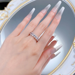 Close-up of S925 silver eternity ring featuring oval-cut stones on a hand