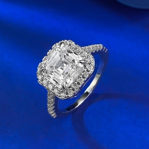S925 silver Asscher cut zircon ring with halo setting on royal blue satin background
