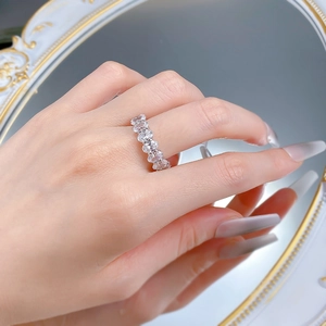 Close-up of S925 silver eternity ring with oval-cut zircons on a vintage mirror