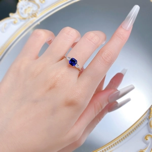 Close-up of S925 silver ring with cushion-cut blue sapphire and marquise side stones