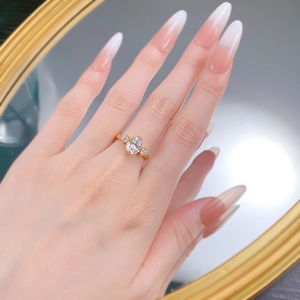 Classic gold S925 silver ring featuring an oval-cut center stone on a person's finger