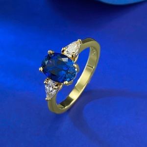 Classic S925 silver gold-plated ring featuring an oval blue sapphire and white zircons