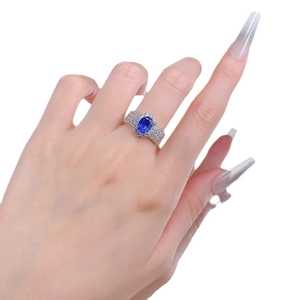 Elegant S925 silver ring featuring an oval blue sapphire center with diamond halo